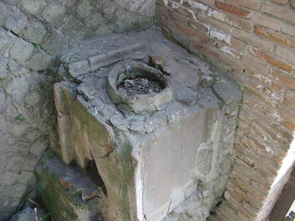 Decumanus Maximus, Herculaneum, number 8, May 2003.
Looking towards east side of entrance doorway, and fittings for the box built with tiles.
Photo courtesy of Nicolas Monteix.
According to Monteix,
“Wedged, on the right, between the entrance doorway and the eastern wall, a small structure served as a support for three tiles.
The tile forming the north face is pierced by a semi-circular opening of about 30cm which would have been used as a mouth to feed the hearth.
The socket would then have served as a support for the dishes used for cooking, or even water heaters using a ceramic container.”
See Monteix, N. 2010. Les lieux de metier. Boutiques et ateliers d’Herculanum. (p.100).
Photo courtesy of Nicolas Monteix.
According to Monteix,
“Another system, less frequently used, was employed at Herculaneum, in shop No. 8
Wedged, on the right, between the entrance doorway and the eastern wall, a small structure served as a support for three tiles.
The tile forming the north face is pierced by a semi-circular opening of about 30cm which would have been used as a mouth to feed the hearth.
The socket would then have served as a support for the dishes used for cooking, or even water heaters using a ceramic container.”
See Monteix, N. 2010. Les lieux de metier. Boutiques et ateliers d’Herculanum. (p.100)